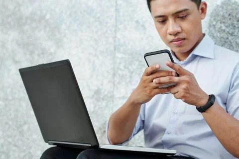 Software developer checking messenger Foto stock