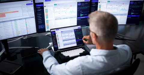 Software Developer Closely Watches API Traffic On Laptop For Security. Fotos Stock
