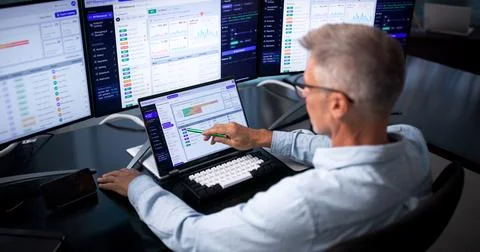 Software Developer Closely Watches API Gateway Traffic On Laptop Screen. Stock Photos