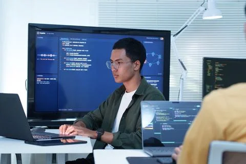 Software Developer Coding in a Collaborative Technology Office Fotos Stock