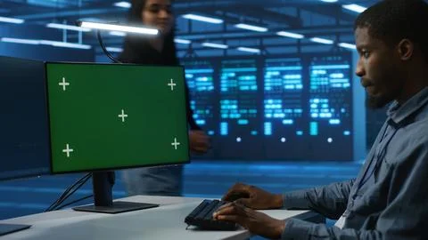 Software developer coding on green screen computer, upgrading equipment 库存照片