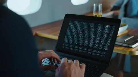 Software developer coding on laptop computer while traveling inside private.. Stock Footage 337441220