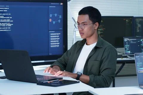 Software Developer Coding on Laptop in Modern Technology Office Fotos Stock