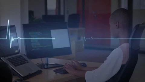 Software developer coding, launching ECG, scrolling heartbeat waveform on Stock Footage 329851015