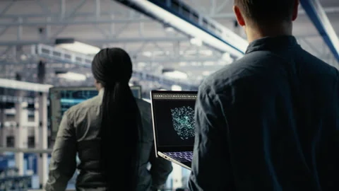 Software developer in data center checks AI dashboard using laptop Stock Footage 314685415