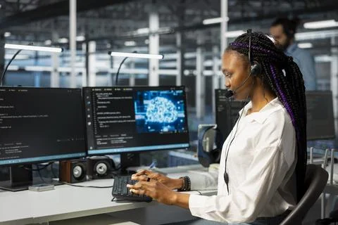 Software developer in data center uses headset mic to provide user tech support Stock Photos