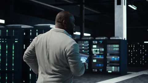 Software developer in data center using tablet, employing machine learning Stock Footage 311831305