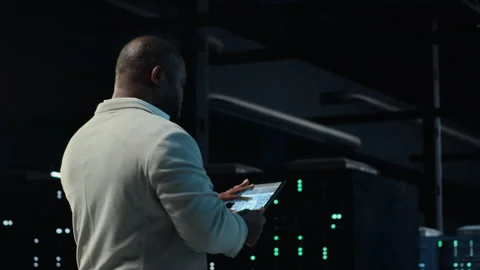 Software developer in data center using tablet, employing machine learning Stock Footage 311833513