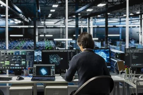 Software developer in data center using PC, managing AI training datasets 写真素材