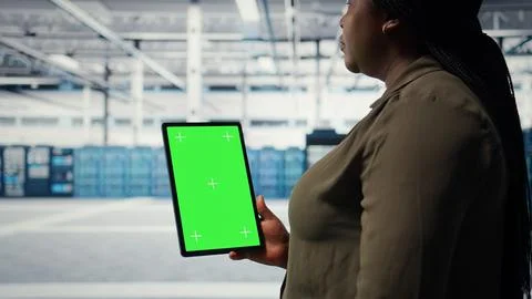 Software developer in data center using green screen tablet Stock Photos