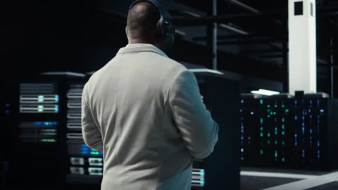 Software developer in data center workspace coding on tablet Stock Footage 311898724