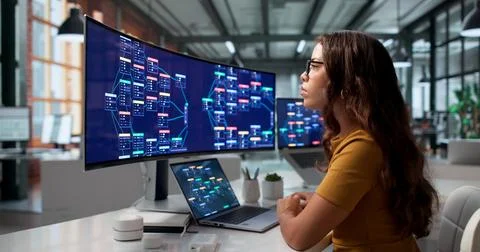 Software Developer Designs Visual Automation Workflows Quickly On Laptop. Stock-Fotos