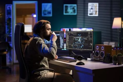 Software developer drinking coffee, watching AI on screen gaining humanoid form Stock Photos