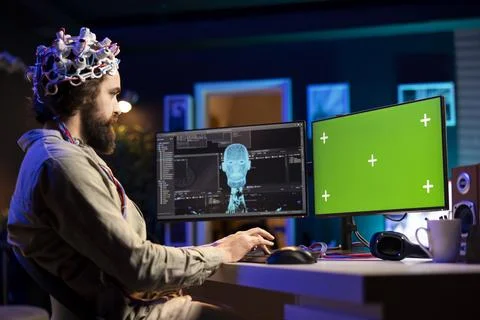 Software developer with EEG headset on writing code 스톡 사진