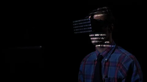 Software developer experiencing virtual reality goggle glasses at night in a  Stock Footage 86451876