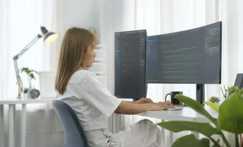 Software developer freelancer woman working with program code on wide displ.. Stockfoto's