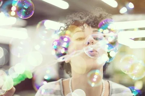 Software developer having fun while making soap bubble Foto stock