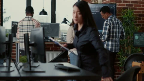 Software developer holding digital tablet analyzing code on wall screen tv Stock Footage 168235103