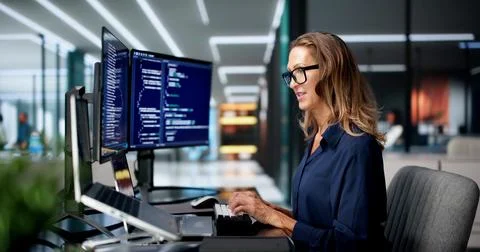 Software Developer Intently Coding Secure Cloud Applications On Laptop At Off Fotos Stock