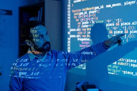 Software Developer Interacting with Projected Code 스톡 사진