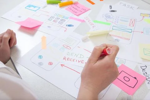 Software developer makes structure app for modern mobile phone. Stock Photos