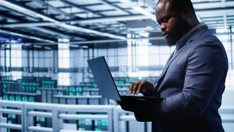 Software developer monitoring server hub hardware energy consumption with laptop Video stock 277646662