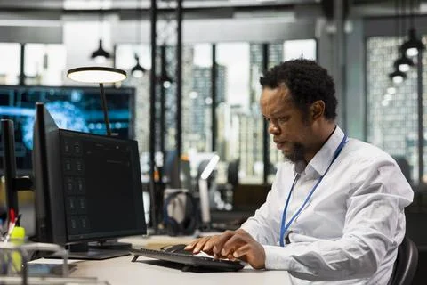 Software developer at office desk using machine learning programming languages Stock Photos
