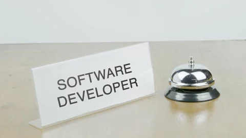 Software Developer Office or Room with Hand Ringing The Bell on Desk Stock Footage 300825421