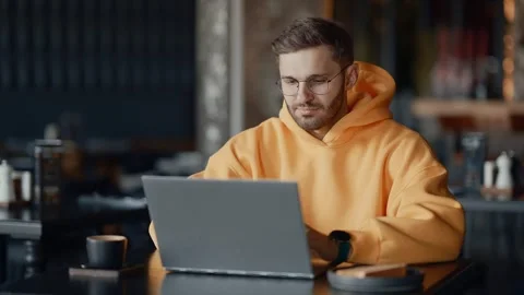Software Developer Or Web Designer Working Remotely With Laptop In City Cafe Vídeo Stock 343668906