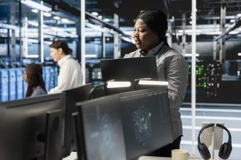 Software developer overseeing server clusters doing data intensive operations Stock Photos