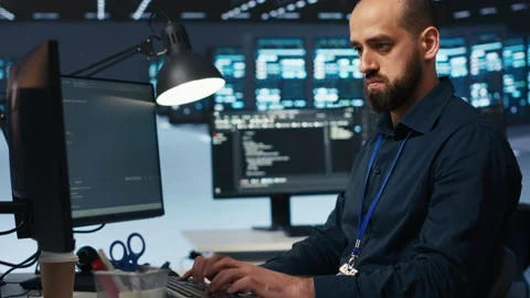 Software developer overseeing servers, running code Stock Footage 275491643