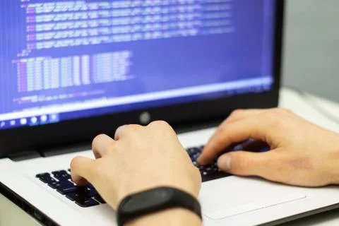 Software developer programming code on a monitor 스톡 사진