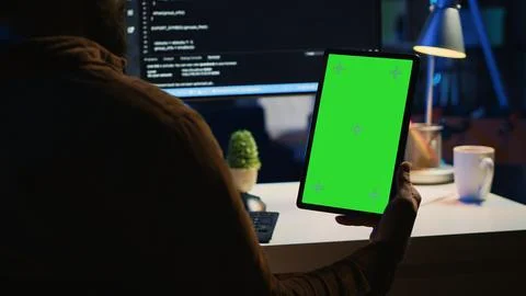 Software developer programming in home office with green screen tablet Foto stock