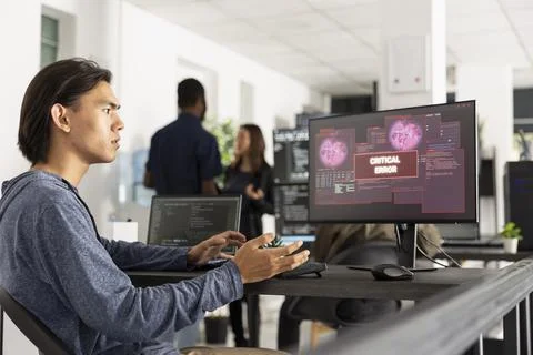 Software developer reacting to critical system error on screen Stock Photos