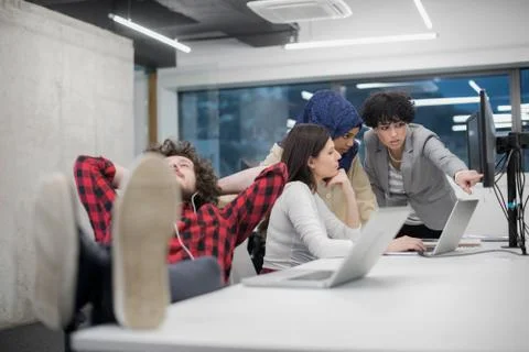 Software developer resting with legs on desk Stock Photos