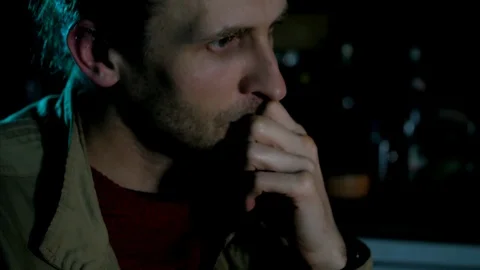 Software developer serious man siting in dark room and thinking close-up  Stock Footage 105465801