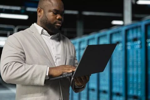 Software developer in server farm managing infrastructure systems Stock Photos