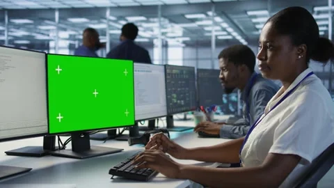 Software developer in server farm safeguarding against hackers with mockup PC Stock Footage 319575008