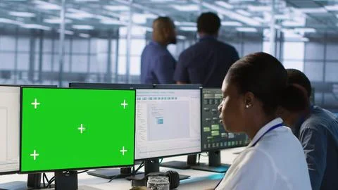 Software developer in server farm safeguarding against hackers with mockup PC Stock Photos