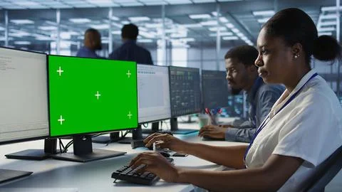 Software developer in server farm safeguarding against hackers with mockup PC Stock Photos