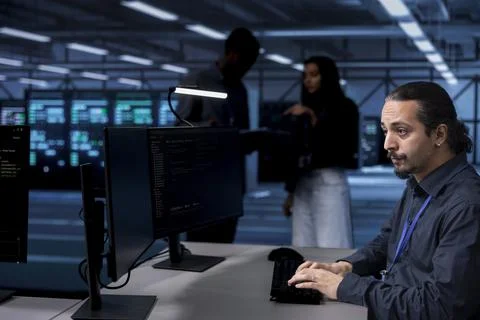 Software developer in server farm tasked to oversee supercomputers Stock Photos