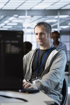 Software developer in server hub maintaining optimal network performance Stock Photos