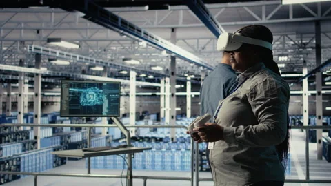 Software developer in server room wearing VR goggles optimizing AI systems Stock Footage 314684280