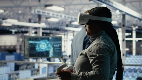 Software developer in server room wearing VR goggles optimizing AI systems Stock Footage 314686312