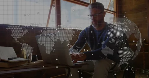 Software developer starting typing on laptop in loft, animated world map Stock Footage 328265305