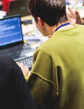 Software developer students in auditorium hall working on computer and lapt.. Stock Photos