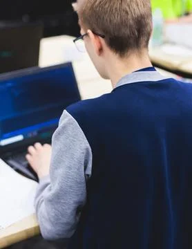 Software developer students in auditorium hall working on computer and lapt.. Stock Photos
