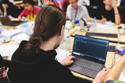 Software developer students in auditorium hall working on computer and lapt.. Stock Photos