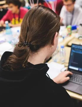 Software developer students in auditorium hall working on computer and lapt.. Stock Photos