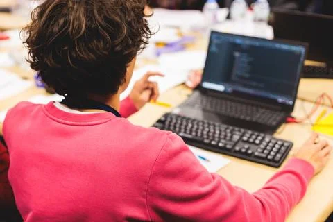 Software developer students in auditorium hall working on computer and lapt.. Stock Photos